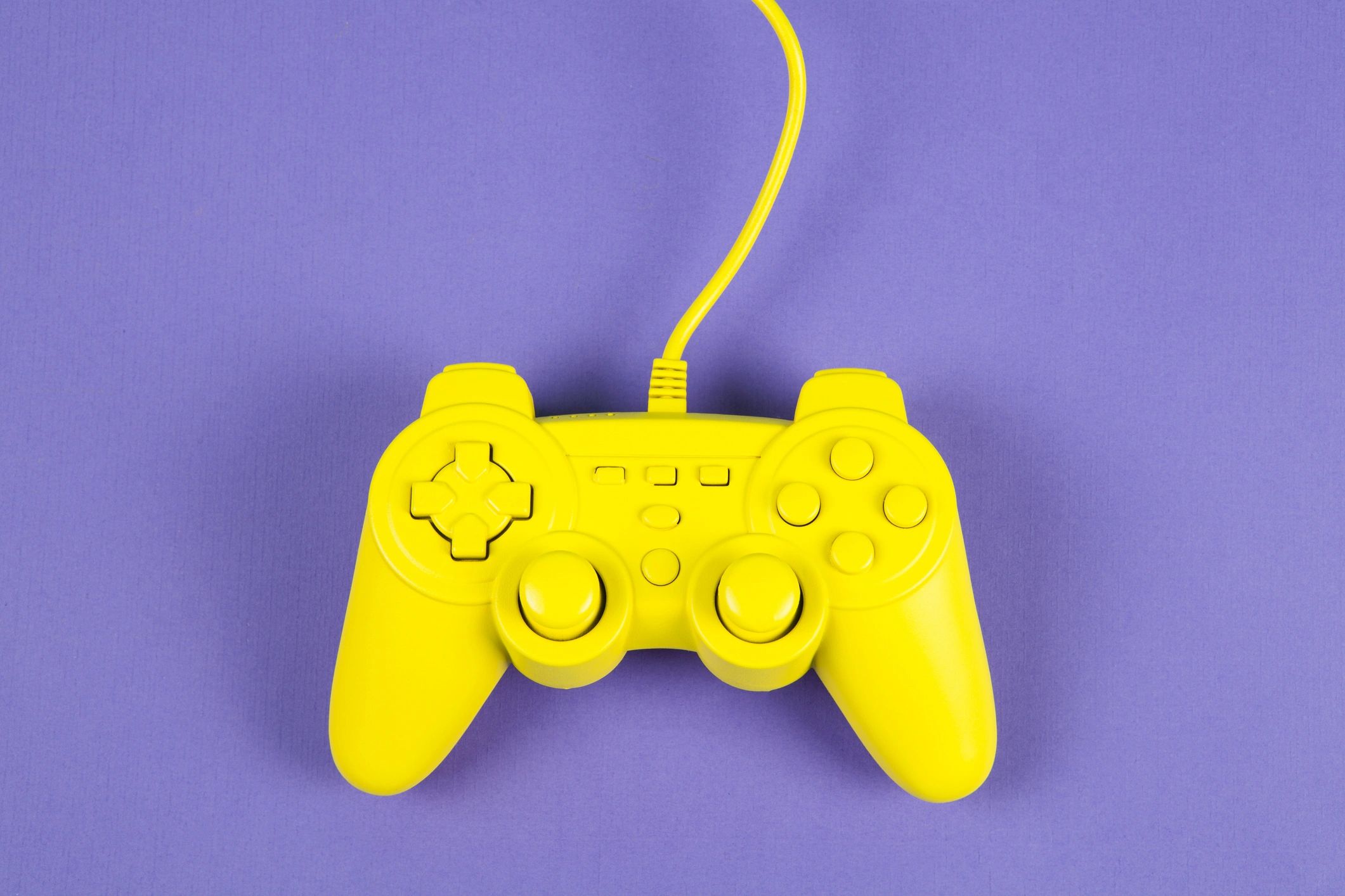 Retro game controller on a purple background