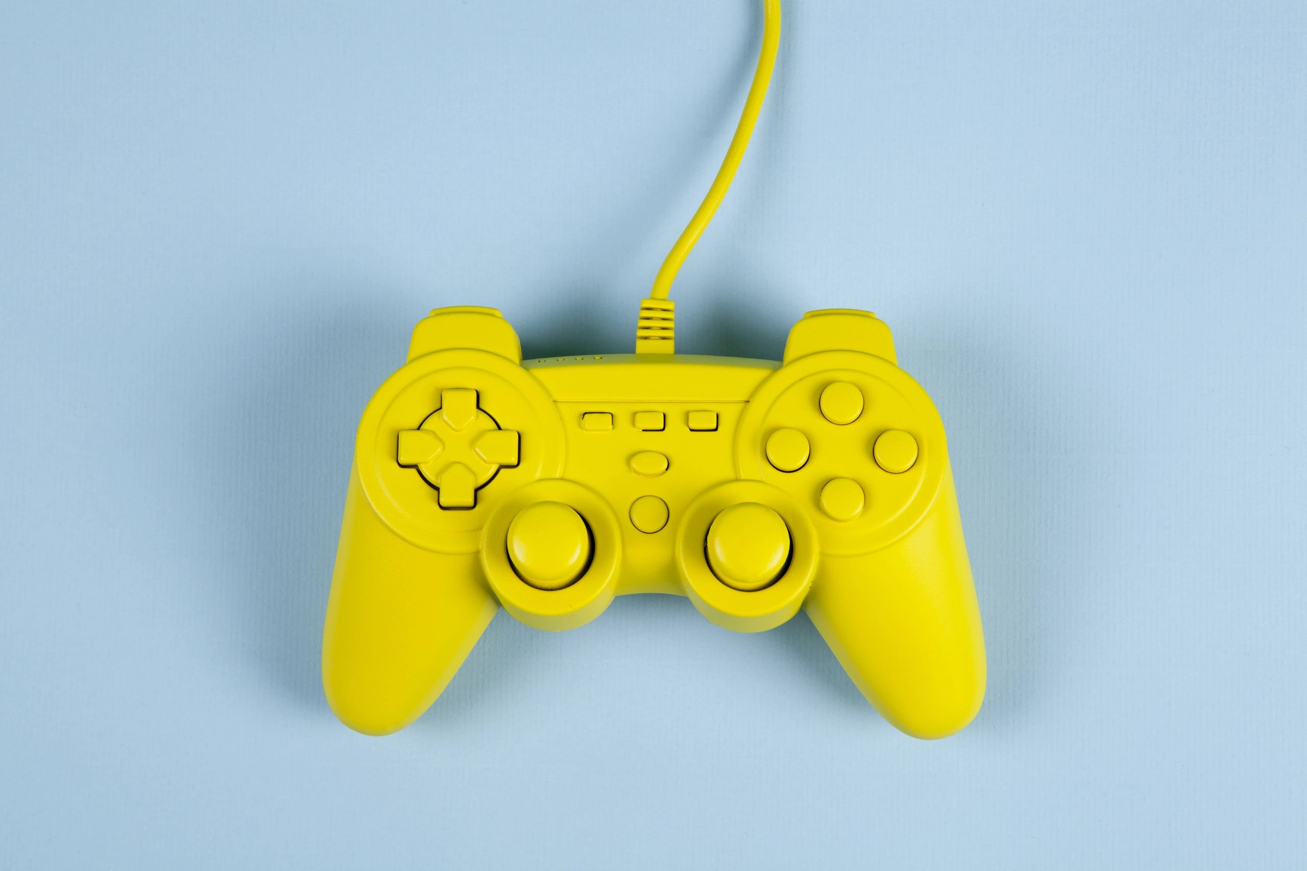 Retro video game controller on a blue background